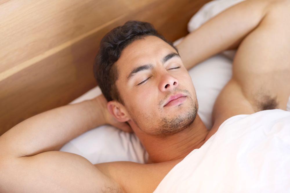 Attractive man sleeping. The Healing Power of Sensual Touch: A Journey into the Calming Depths of the Nervous System.