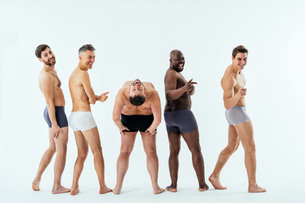 Group of men in their underwear posing for the camera in various positions. They are happy and having fun. Embracing Fluidity: Male Sexuality, Cultural Shifts, and the Power of Erotic Massage