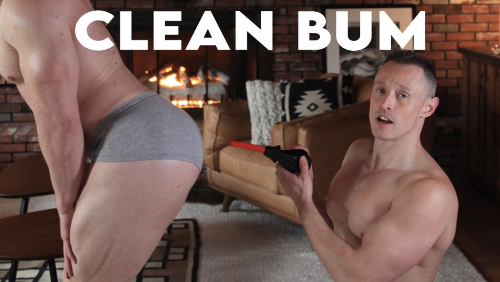 Famous Davey Wavey holding a douche up against another man's bum to show how to clean the anus before prostate massage