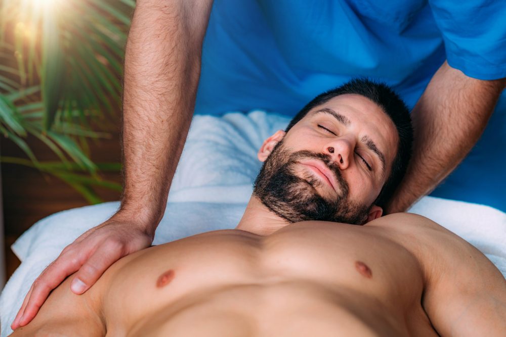 BodGround massage in Ottawa: a male masseur massages his male client